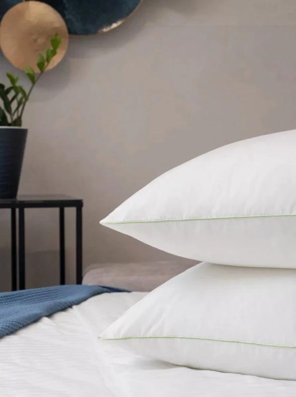 Stacked white Cristina Mille pillows